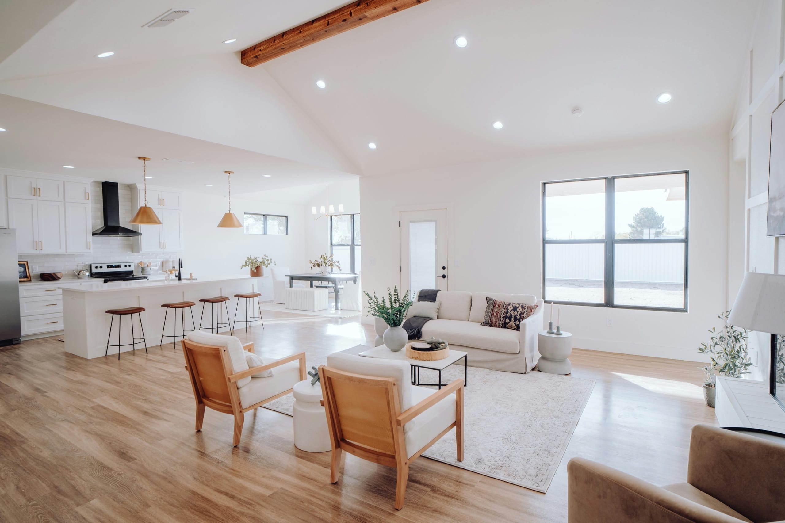 An open living room and kitchen with light wood floors